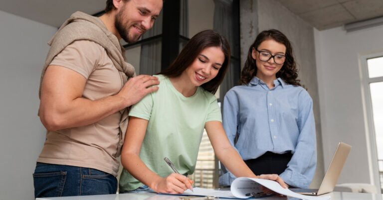 A man and two women while signing mortgage documents